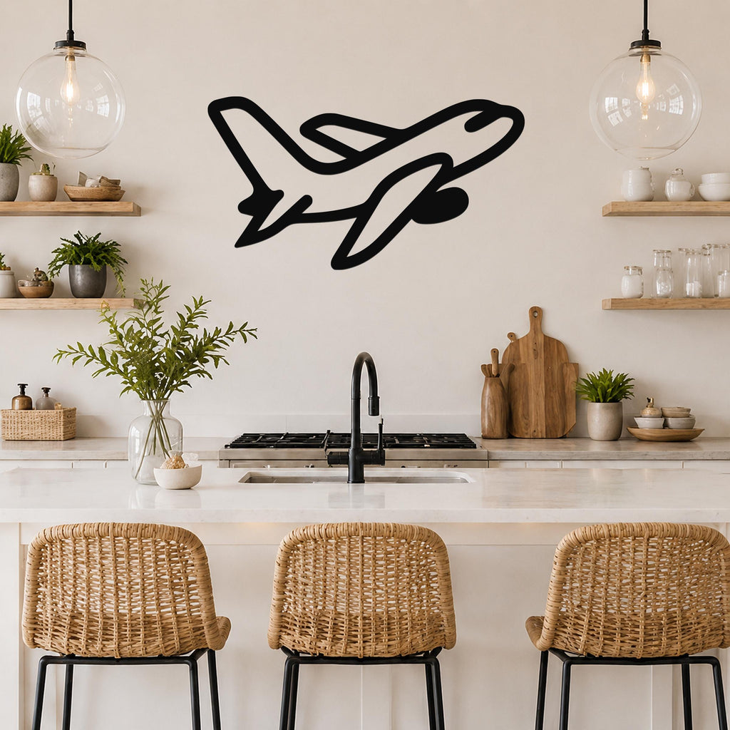 Black metal airplane wall art with a sleek silhouette design, mounted on a kitchen wall above a counter with wicker bar stools.