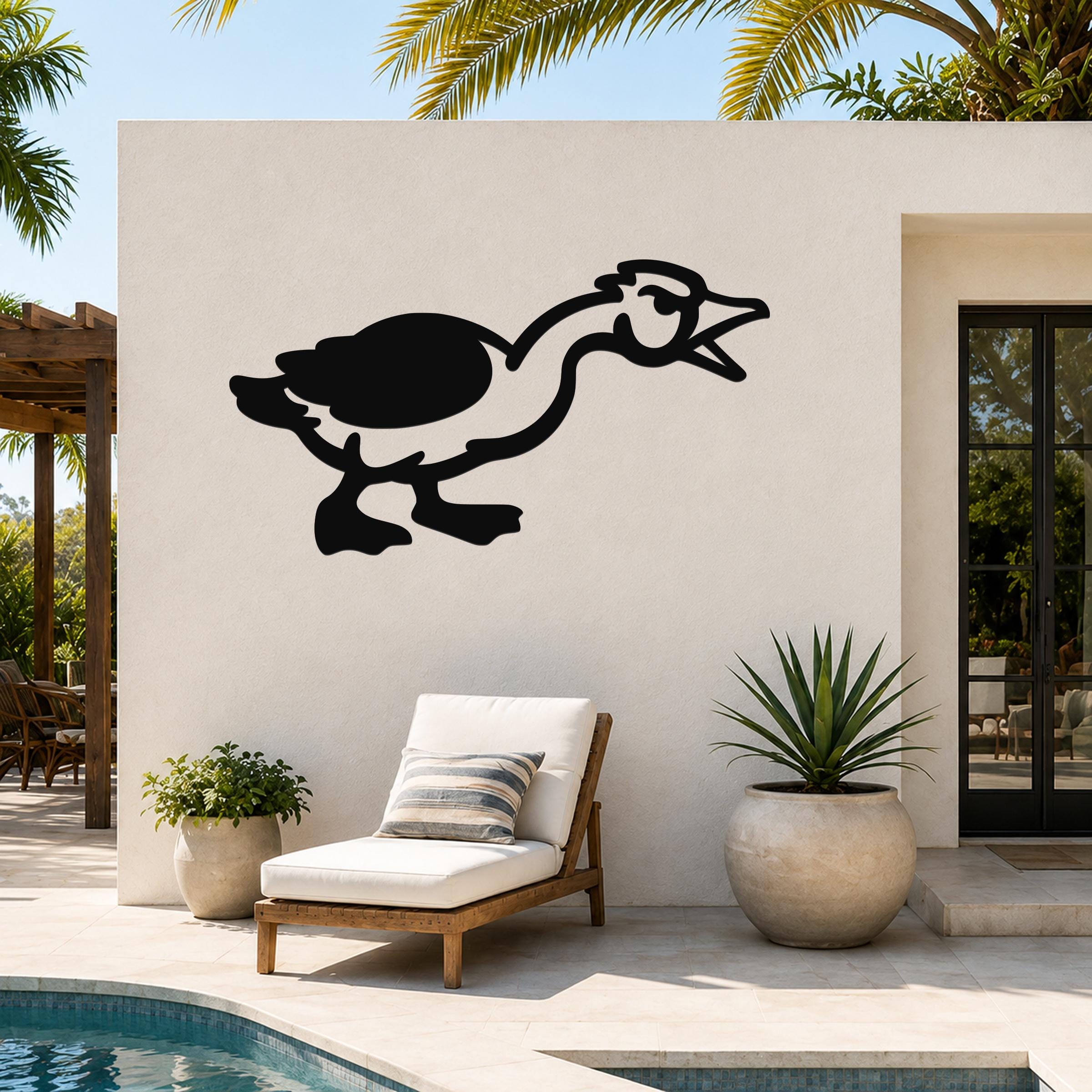 Black metal goose wall art with a minimalist silhouette design, mounted on an outdoor patio wall above a lounge chair and potted plants.