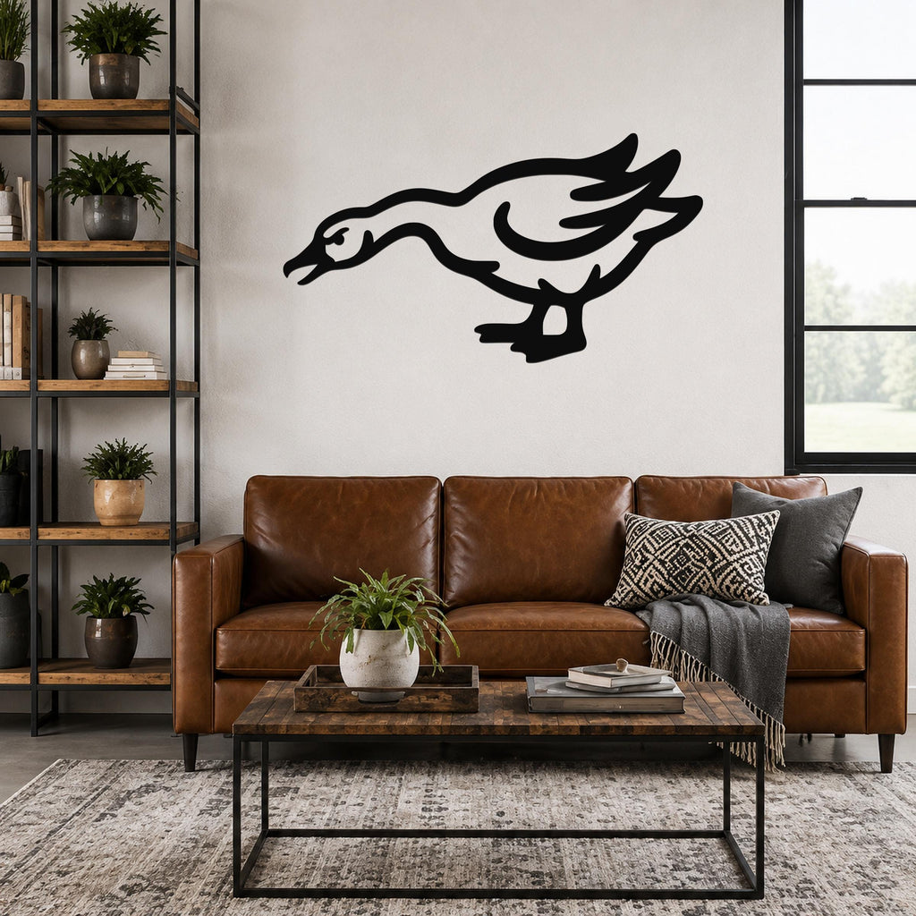 Black metal goose wall art with motion-line cutouts, mounted above a brown leather sofa in a living room.