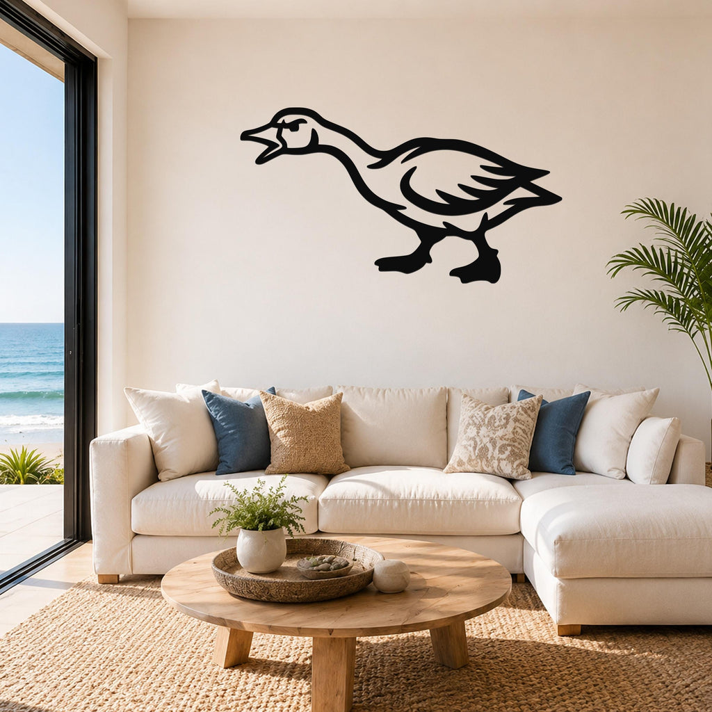 Black metal goose wall art with a bold silhouette design, mounted above a white sofa in a bright living room with ocean views.