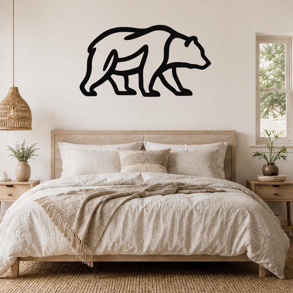 Black metal bear silhouette wall art mounted above a wooden bed in a neutral-toned bedroom.