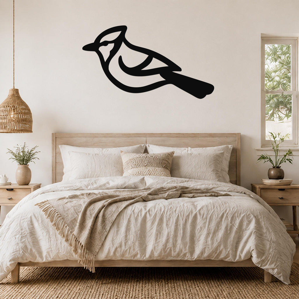 Black metal blue jay wall art silhouette mounted above a bed in a neutral bedroom.