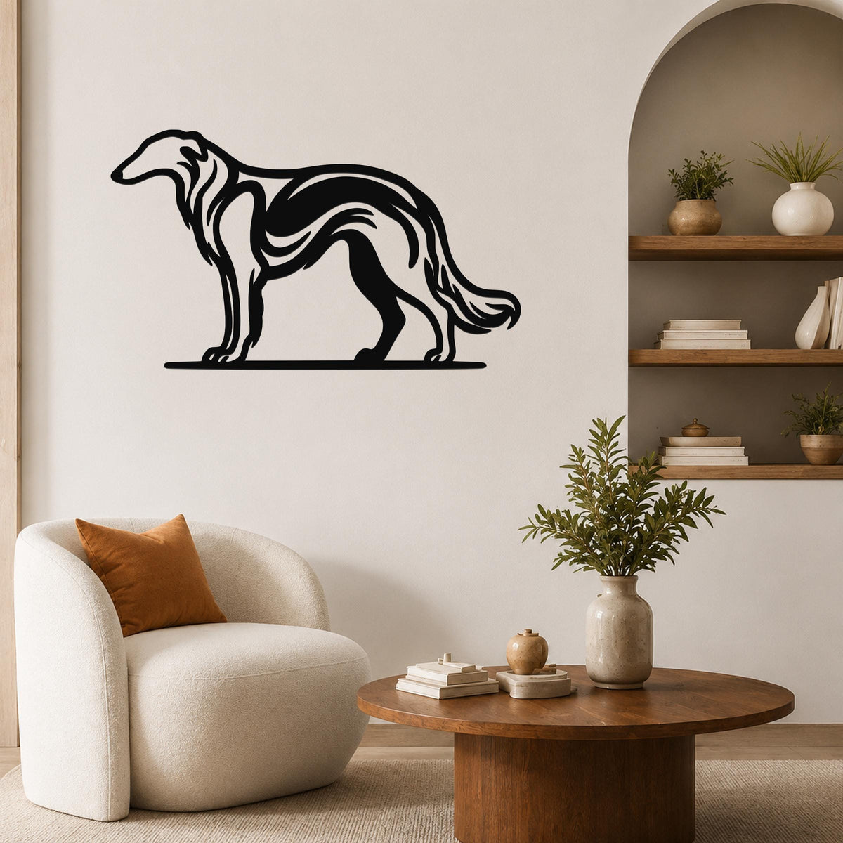Black metal Borzoi dog wall art with flowing internal cutouts, mounted on a living room wall above a white armchair.