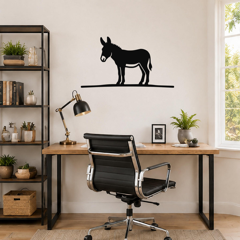 Black metal donkey wall art silhouette mounted above a wooden desk in a home office.
