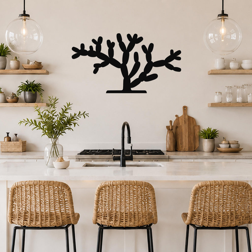 Black metal cholla cactus wall art with branching cutouts, mounted on a kitchen wall above a counter.