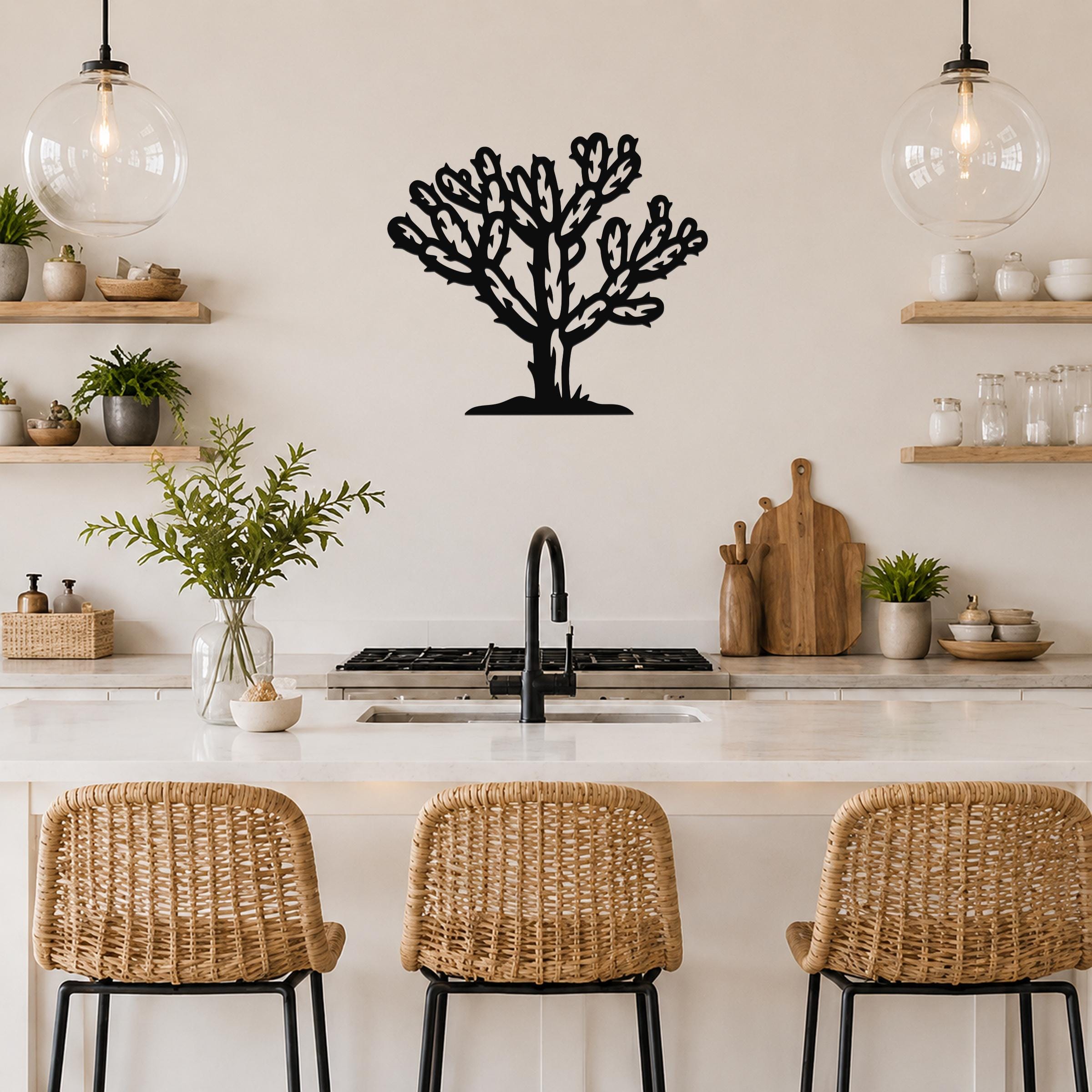 Black metal Cholla cactus wall art with detailed branch cutouts, mounted on a kitchen wall above a counter.