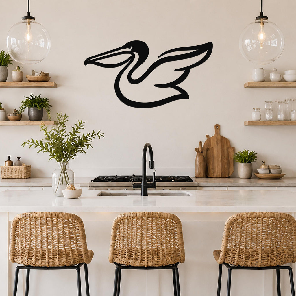 Black metal pelican wall art with a silhouette design, mounted on a kitchen wall above a counter with wicker bar stools.