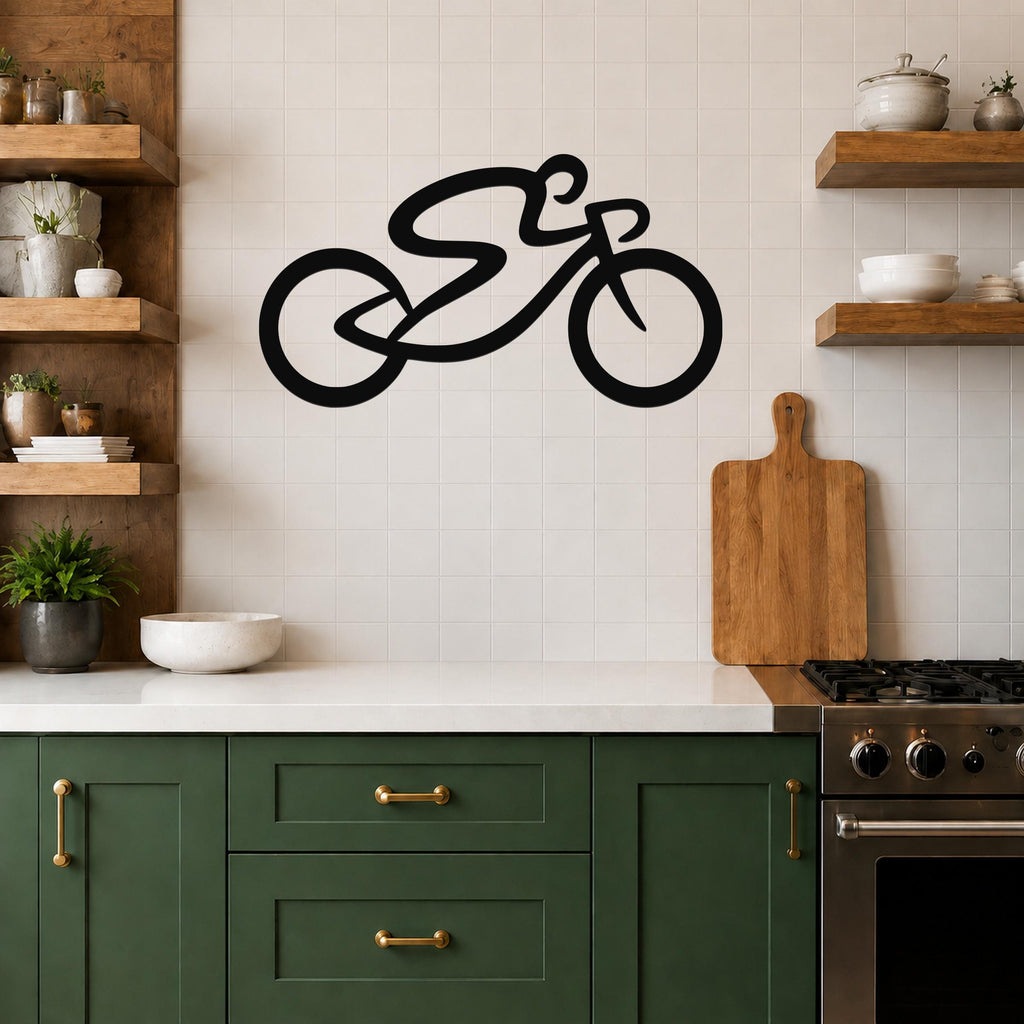 Black metal bicycle wall art with a bold silhouette and dynamic motion lines, mounted on a tiled kitchen wall above a counter.