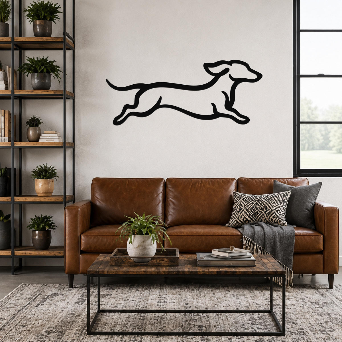 Black metal dachshund wall art with a running silhouette, mounted above a brown leather sofa in a living room.