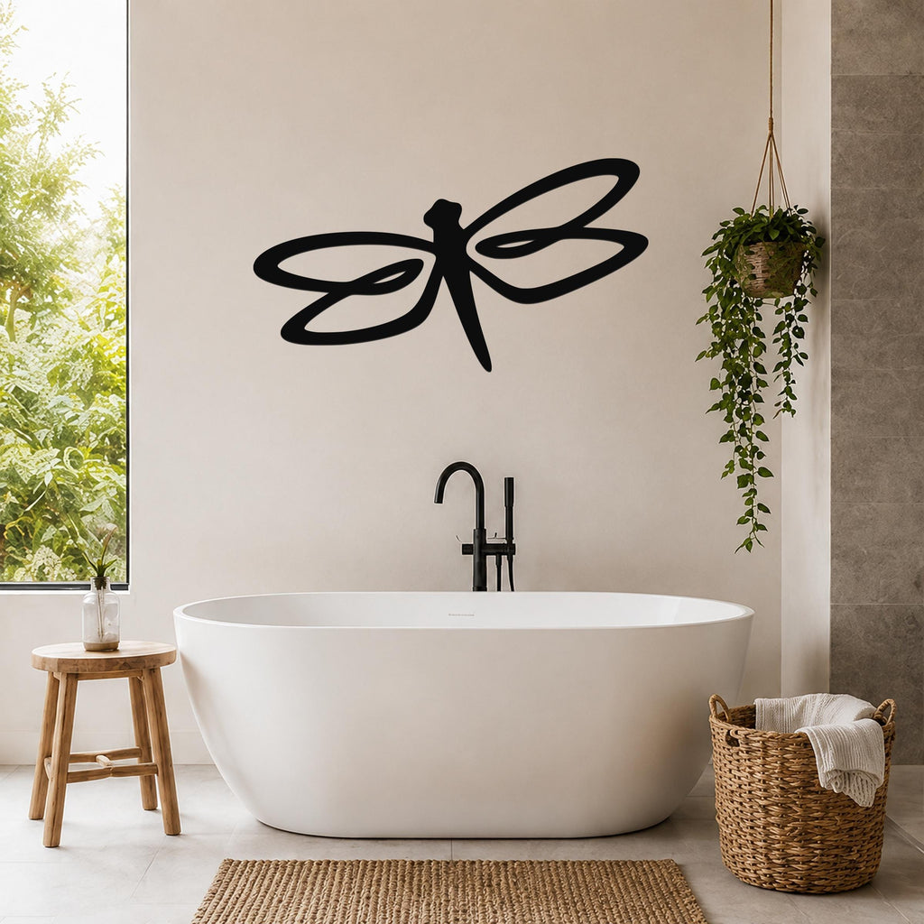Black metal dragonfly wall art with flowing wing cutouts, mounted on a bathroom wall above a freestanding tub.