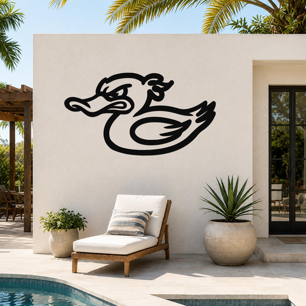 Black metal duck wall art with a bold silhouette design, mounted on an outdoor patio wall above a lounge chair and potted plants.