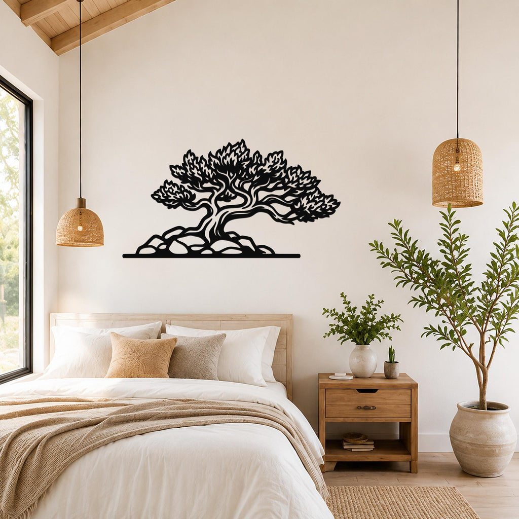 Black metal wall art in a silhouette of a juniper tree with detailed branches and roots, mounted above a bed in a bedroom.