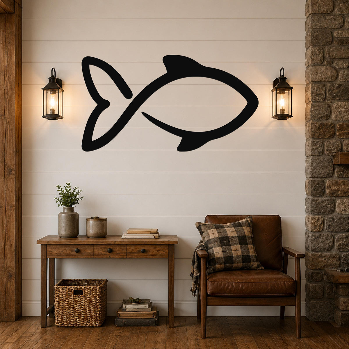 Black metal fish wall art with a silhouette design, mounted on a shiplap wall above a wooden console table in a rustic living room.
