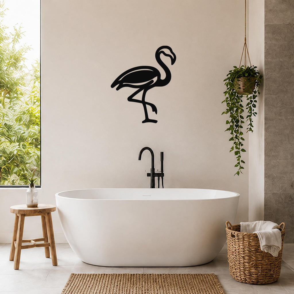 Black metal flamingo wall art silhouette mounted on a bathroom wall above a freestanding tub.