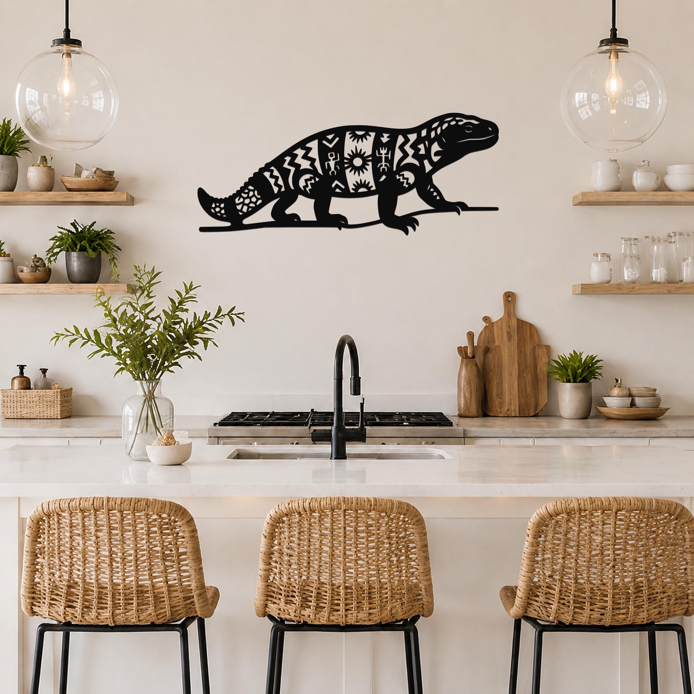 Black metal wall art of a Gila monster with intricate geometric cutouts, mounted above a kitchen counter.