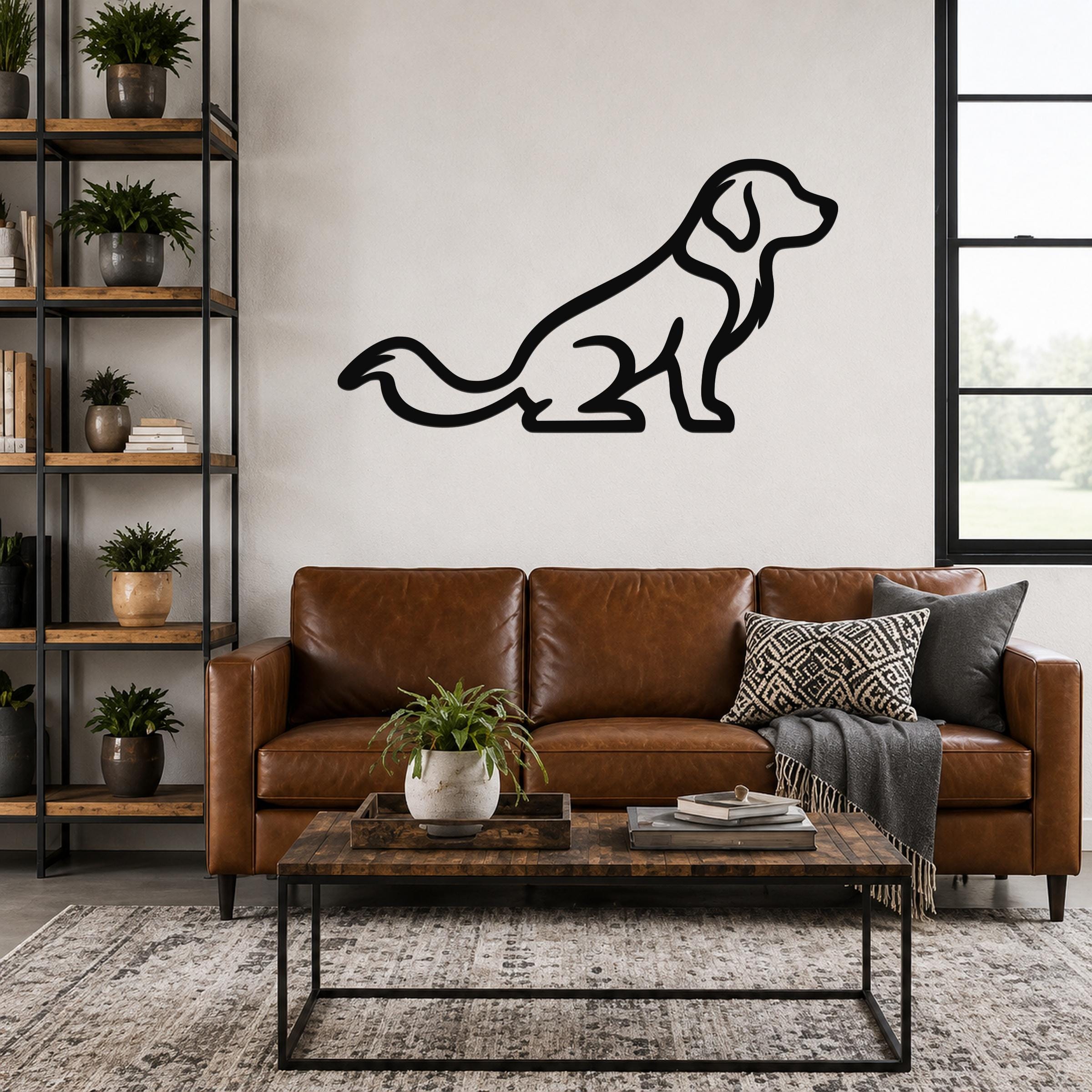 Black metal dog silhouette wall art, a sitting golden retriever with a long tail, mounted on a living room wall above a brown leather sofa.