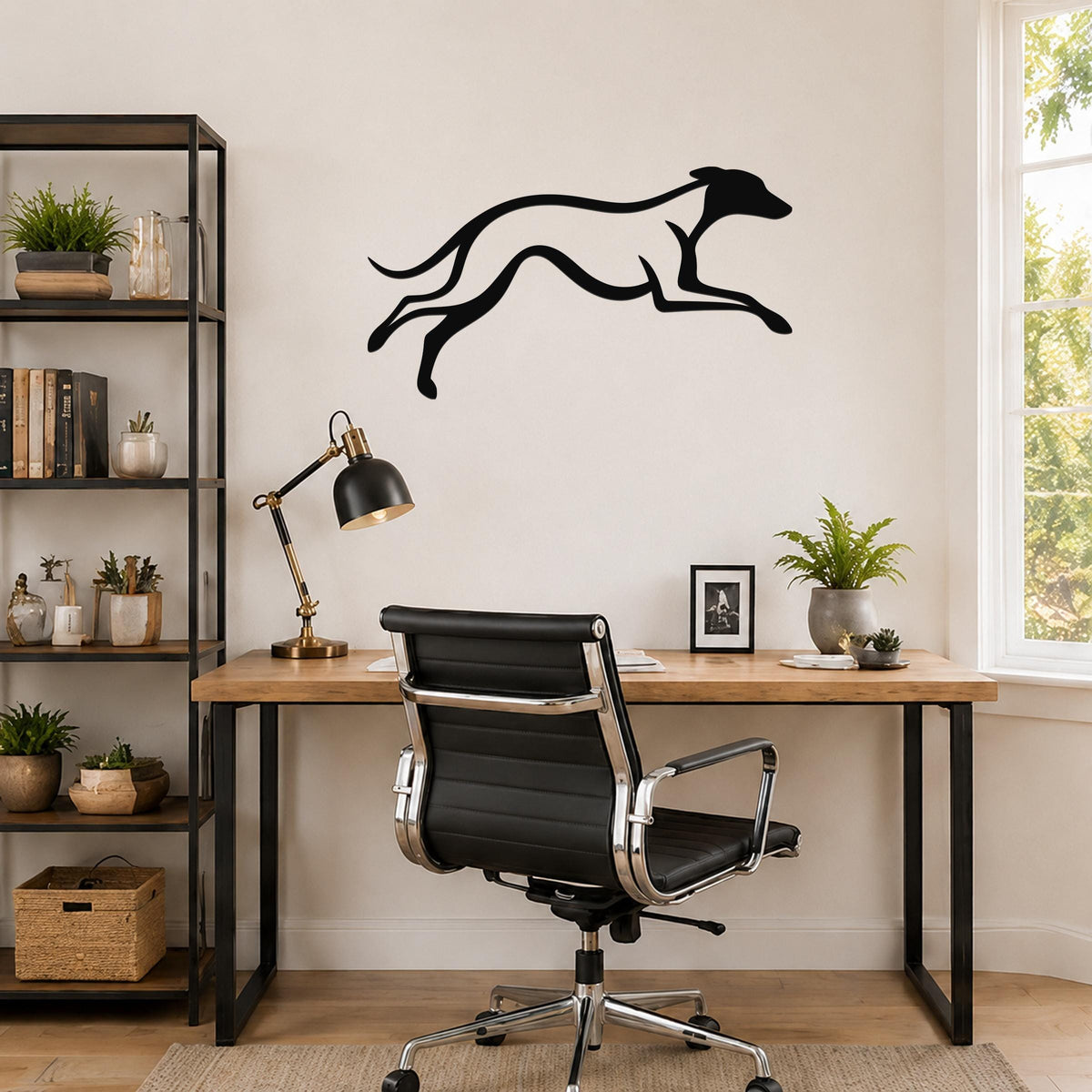 Black metal greyhound wall art with motion-line cutouts, mounted above a wooden desk in a home office.