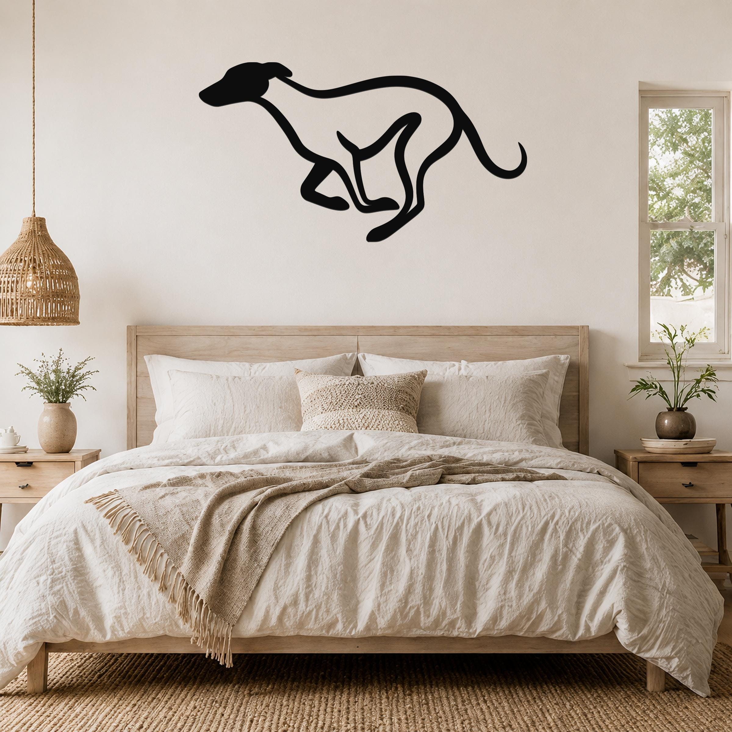 Black metal greyhound wall art in a running silhouette, mounted above a wooden bed in a neutral bedroom.
