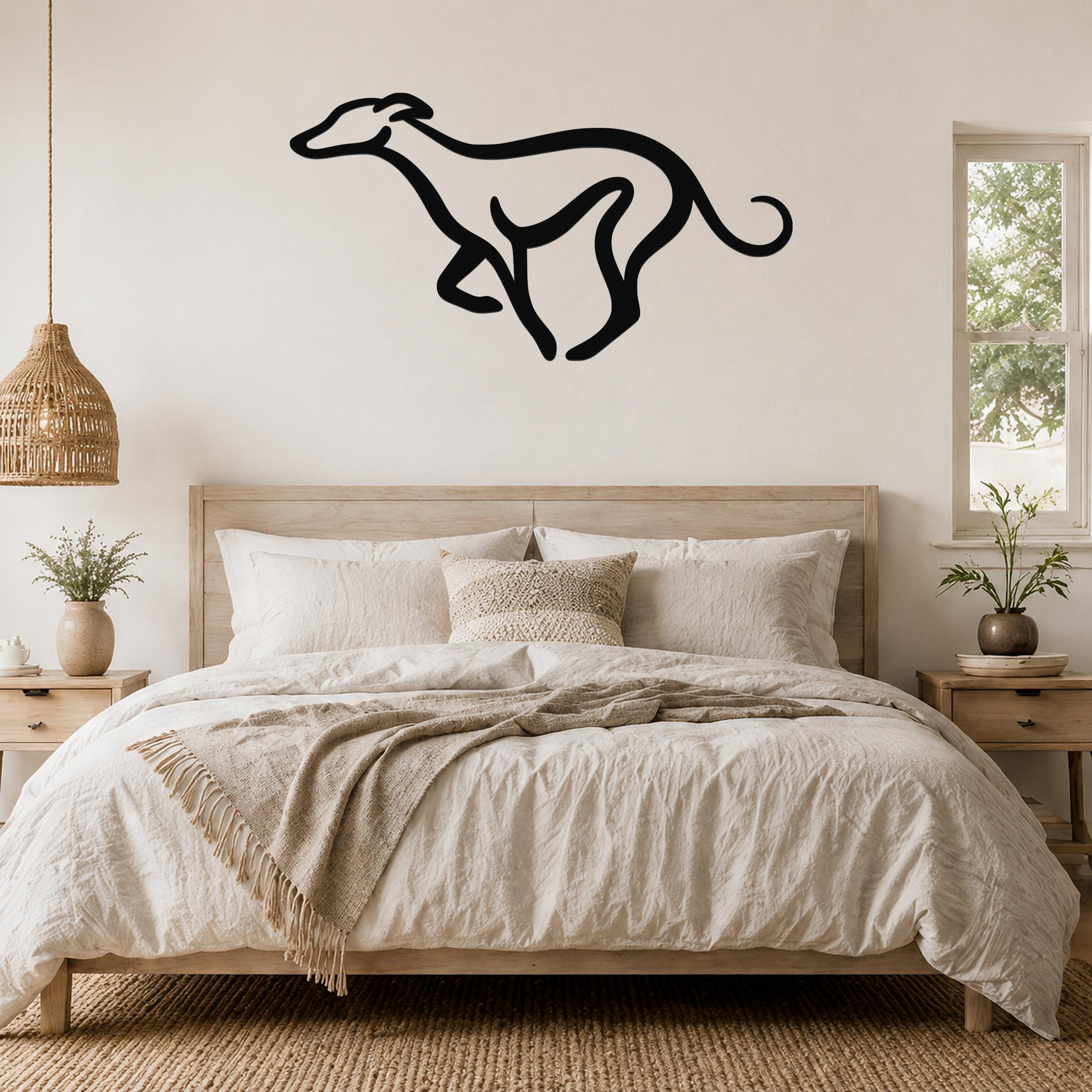 Black metal greyhound silhouette wall art mounted above a wooden bed in a neutral bedroom.