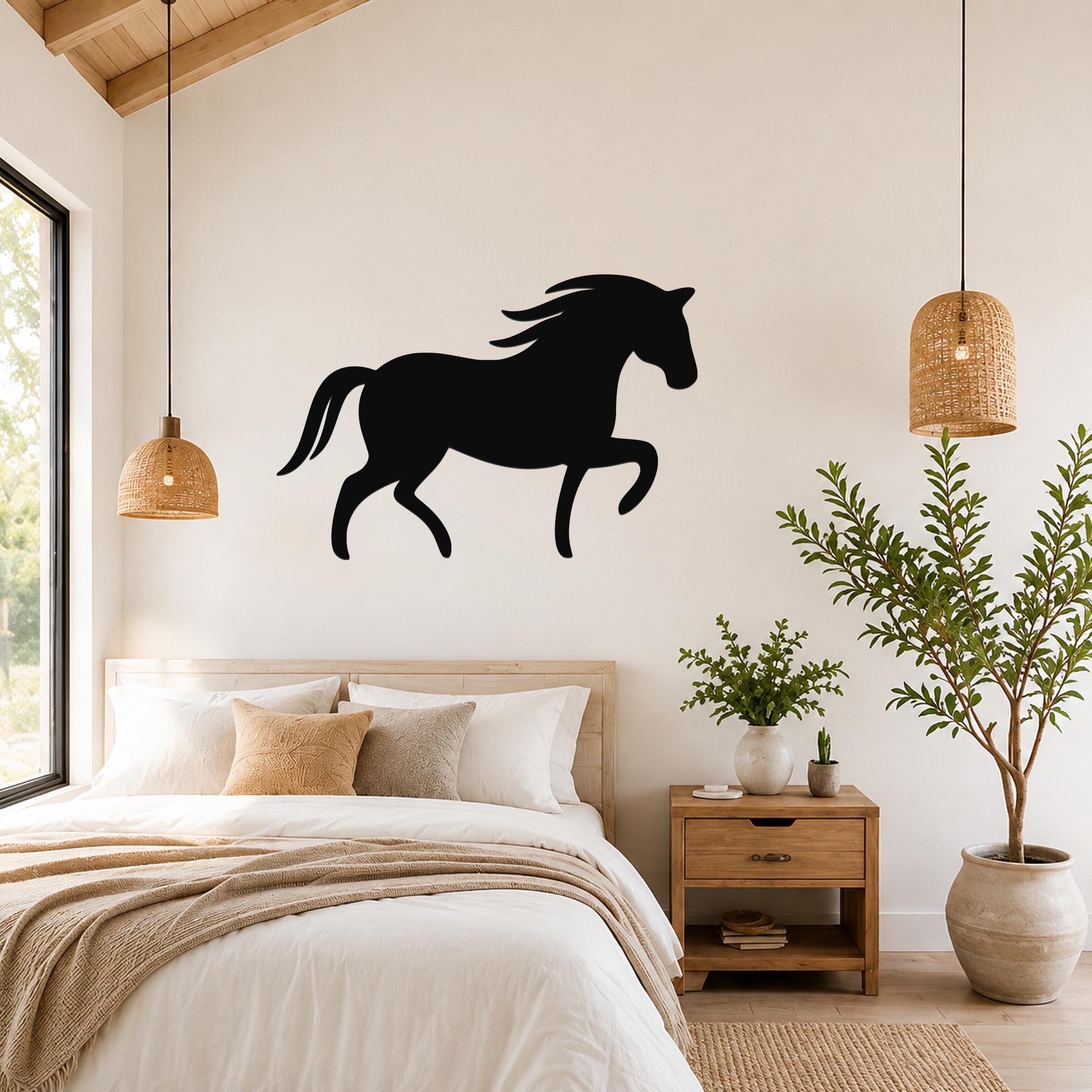 Black metal horse wall art silhouette with flowing mane and tail, mounted above a bed in a rustic bedroom.