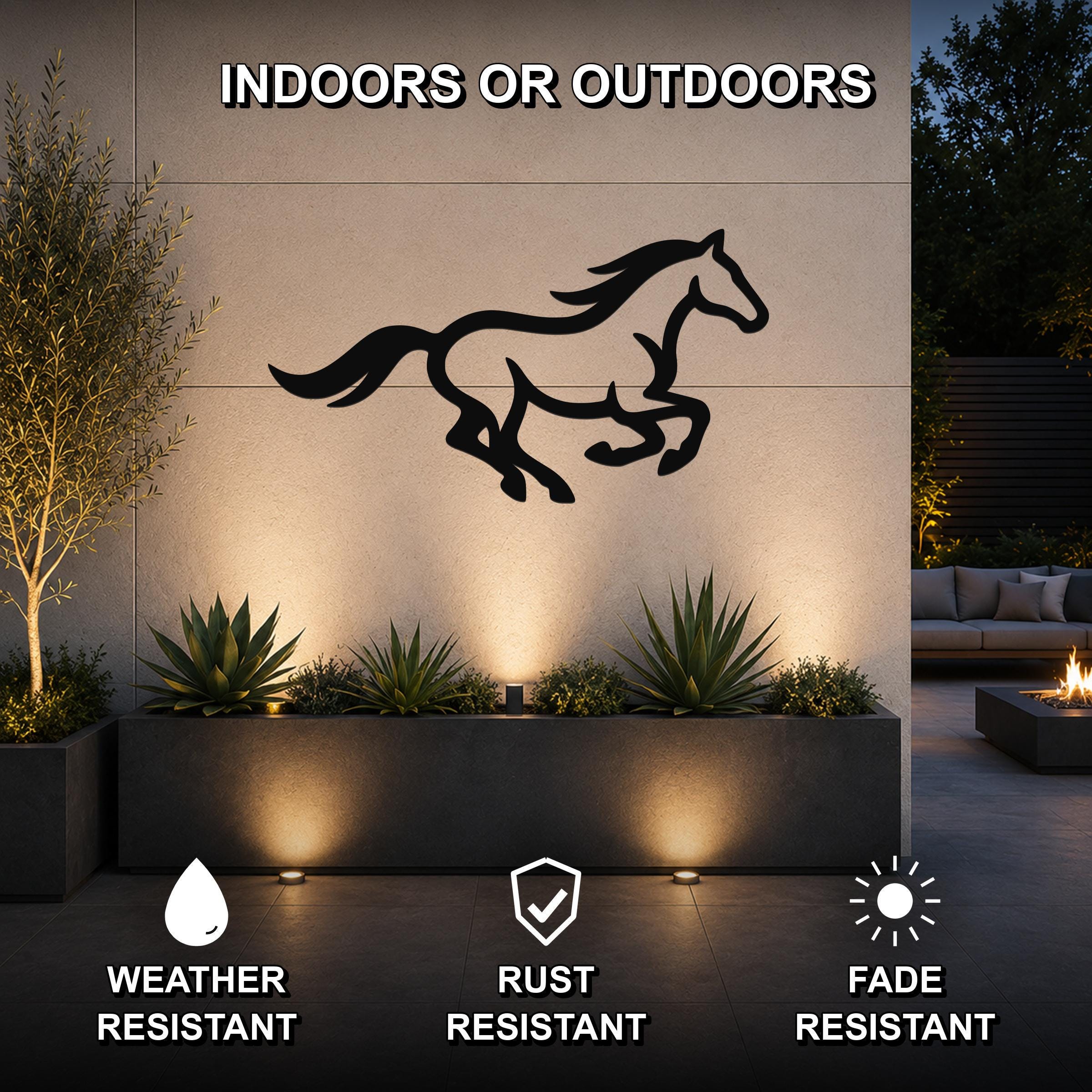 Black metal horse wall art with motion-line cutouts, mounted on an outdoor wall above a planter in a patio setting.