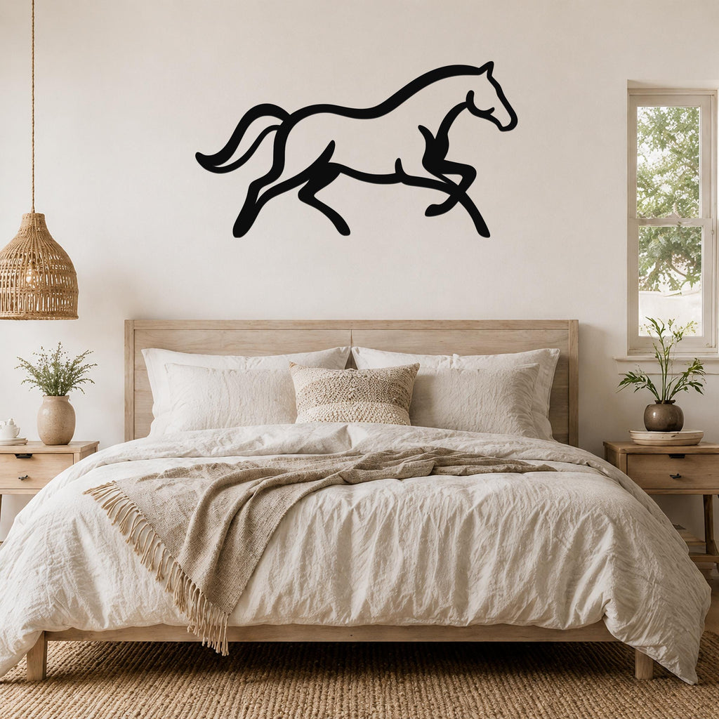 Black metal horse wall art in a running silhouette, mounted above a bed in a neutral bedroom.