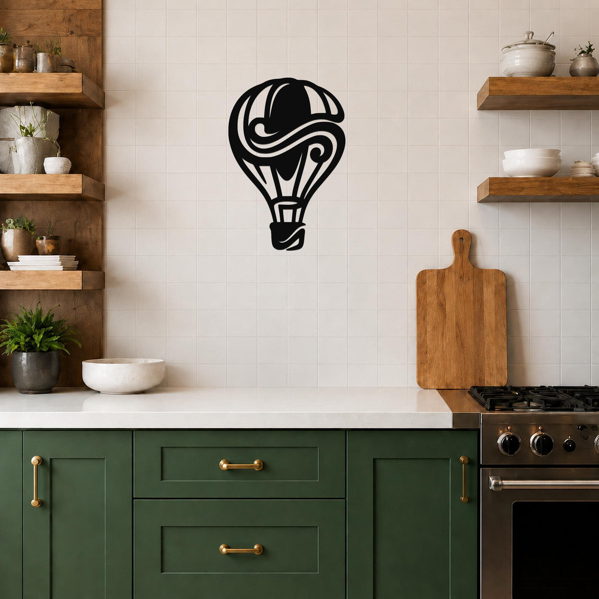 Black metal wall art in a bold hot air balloon silhouette with swirling internal cutouts, mounted on a tiled kitchen wall above a counter.