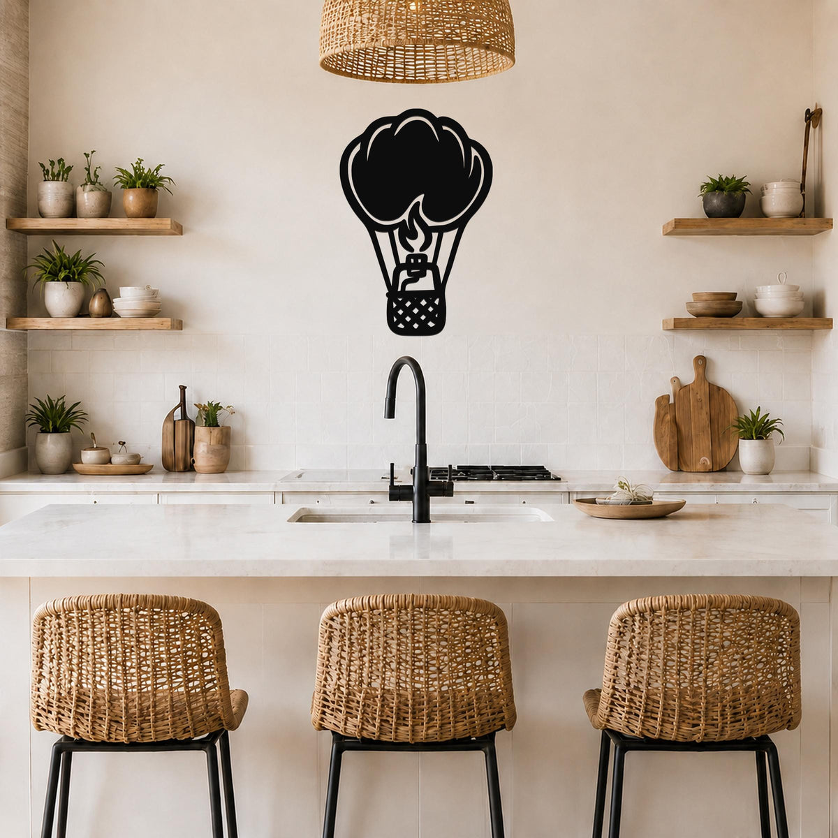 Black metal hot air balloon wall art with flame and basket cutouts, mounted on a kitchen wall above a counter.