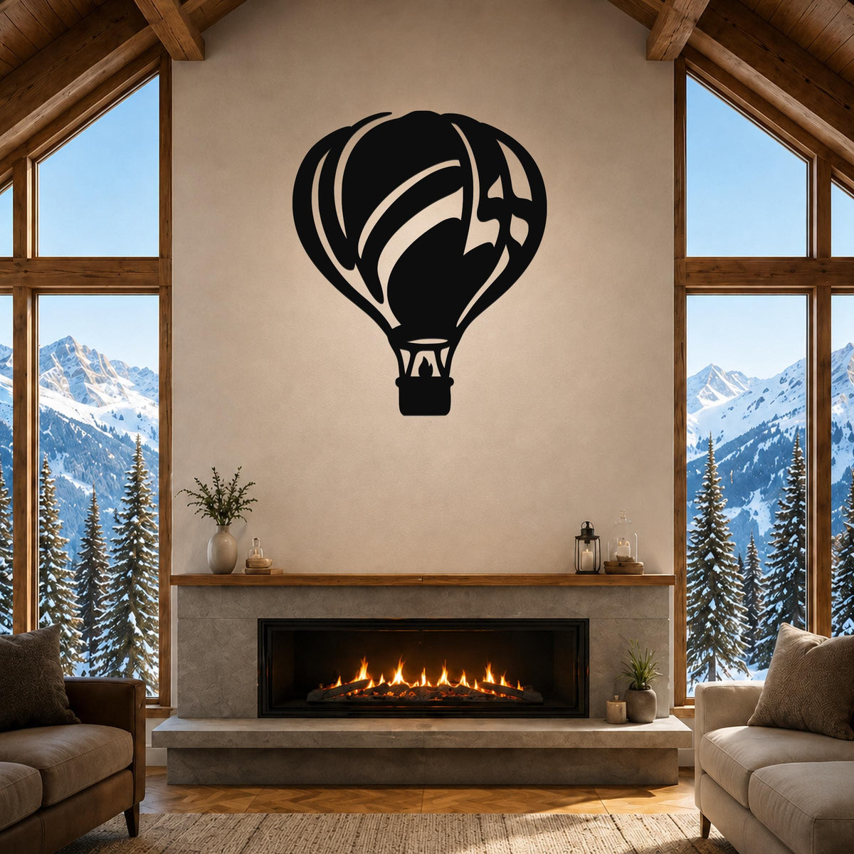 Black metal hot air balloon wall art with internal cutout details, mounted above a fireplace in a living room with large windows and mountain views.