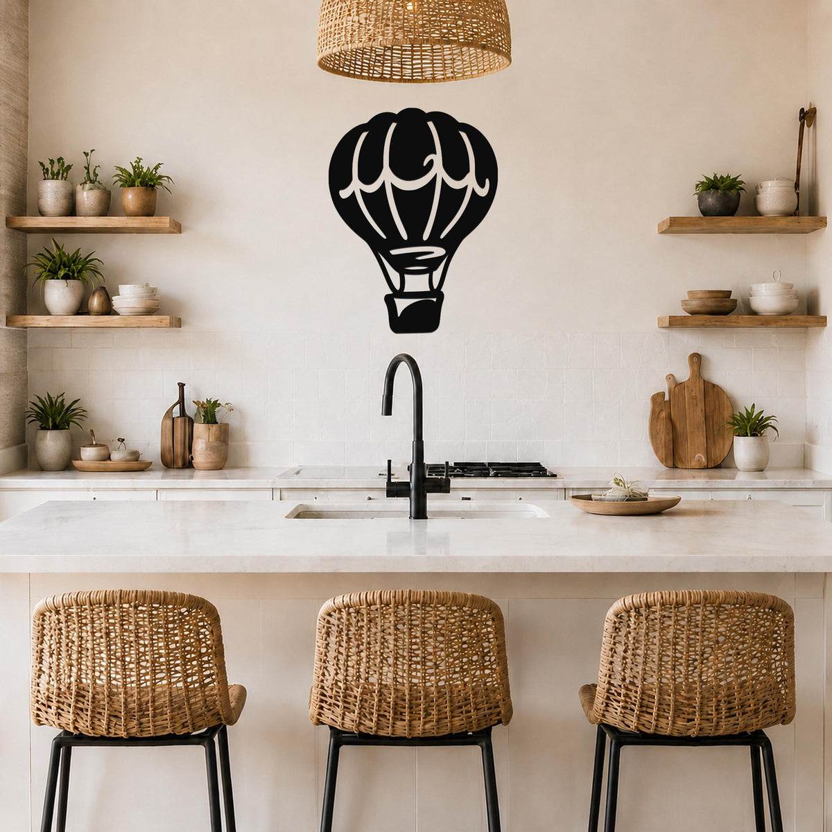 Black metal hot air balloon wall art with internal cutout details, mounted on a kitchen wall above a counter.