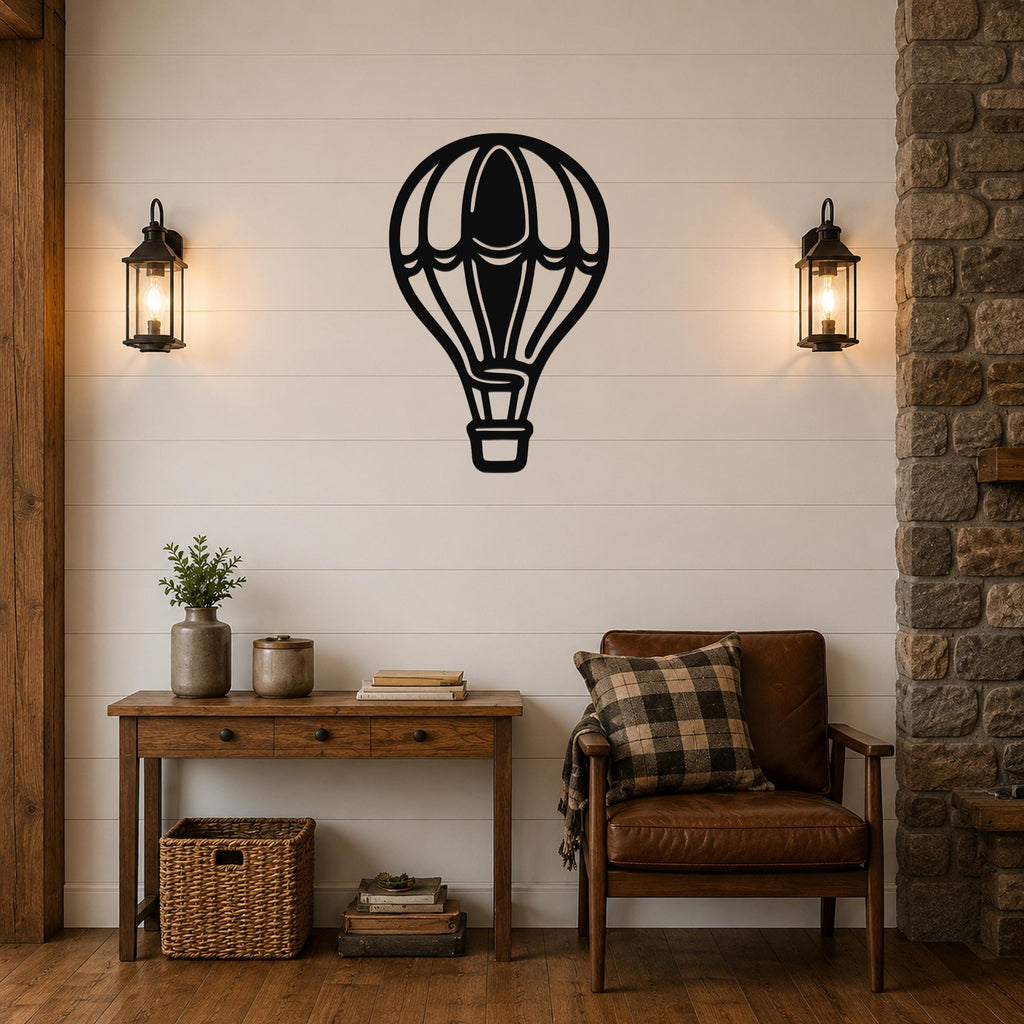 Black metal hot air balloon wall art with internal panel cutouts, mounted on a shiplap wall above a wooden console table in a living room.