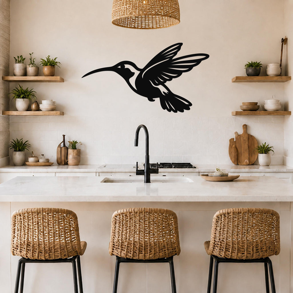 Black metal hummingbird wall art with an airy silhouette design, mounted on a kitchen wall above a counter.