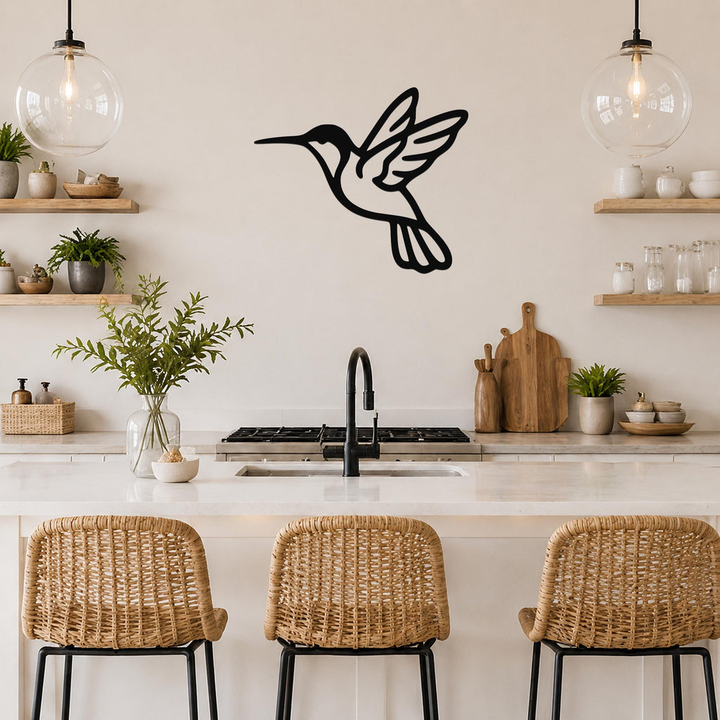 Black metal hummingbird wall art with motion-line cutouts, mounted on a kitchen wall above a counter.