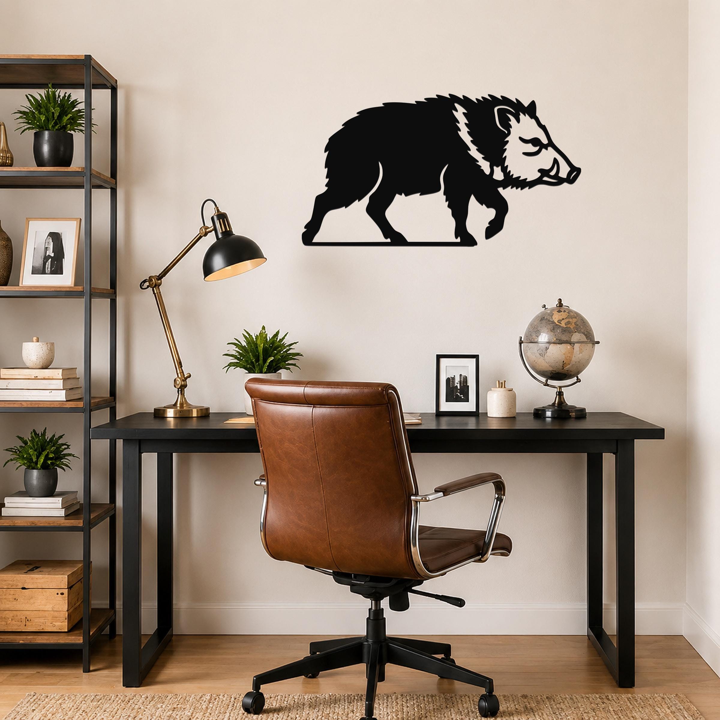 Black metal javelina wall art silhouette mounted above a black desk in a home office.