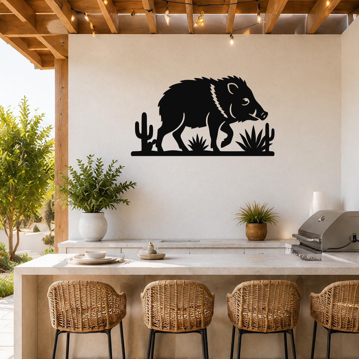 Black metal wall art silhouette of a javelina with cacti and agave, mounted on a white wall above a kitchen counter.