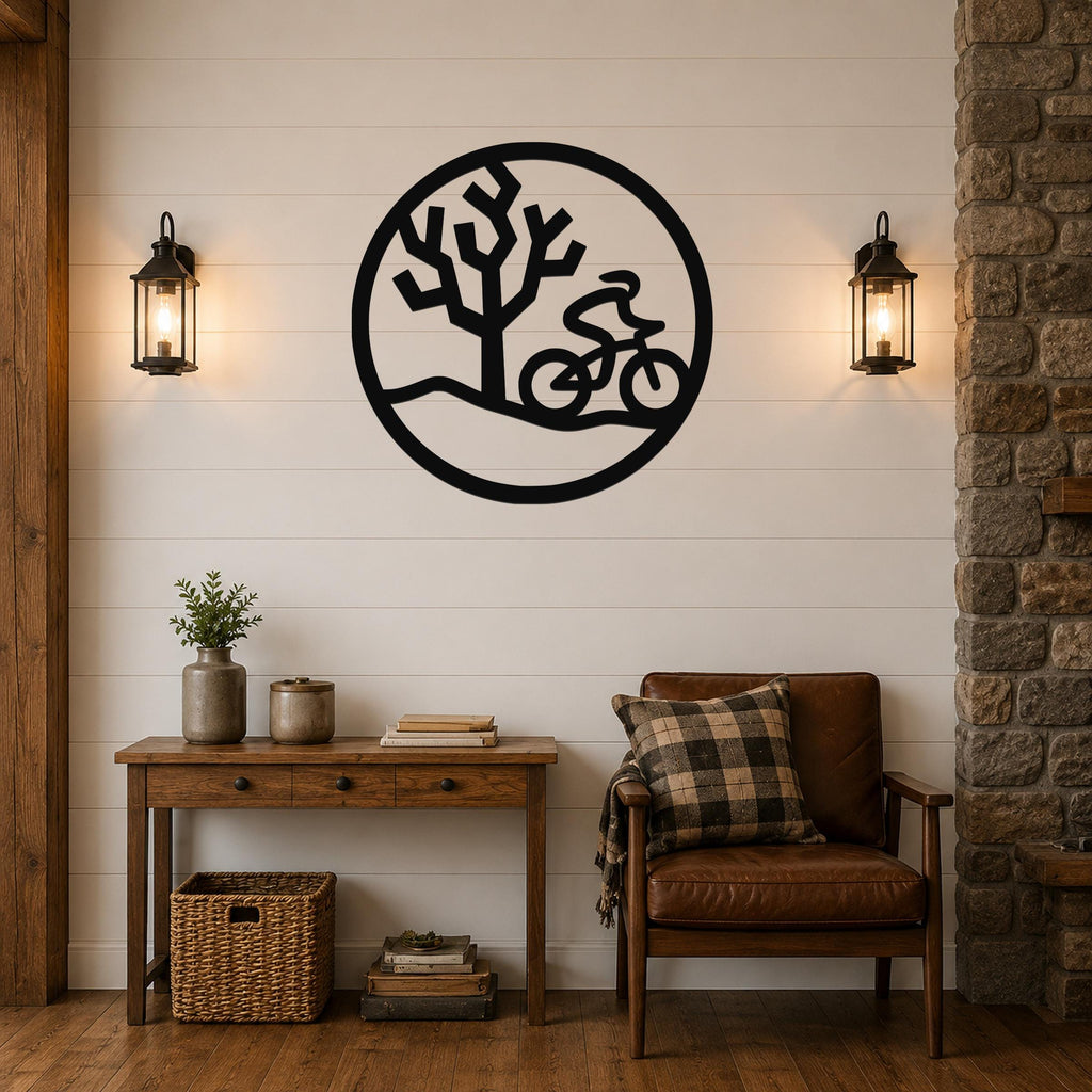 Black metal circular wall art with a cyclist silhouette and tree cutout, mounted on a shiplap wall above a wooden console table in a living room.