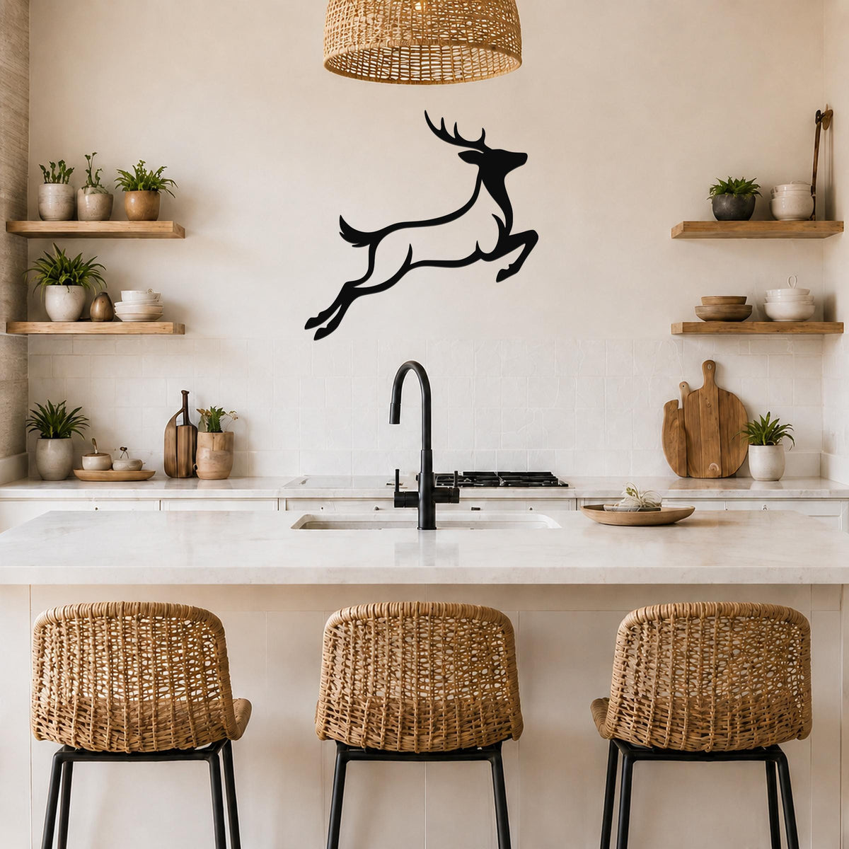 Black metal jumping deer wall art silhouette mounted above a kitchen counter, displayed in a modern rustic kitchen with wooden shelves and woven bar stools.