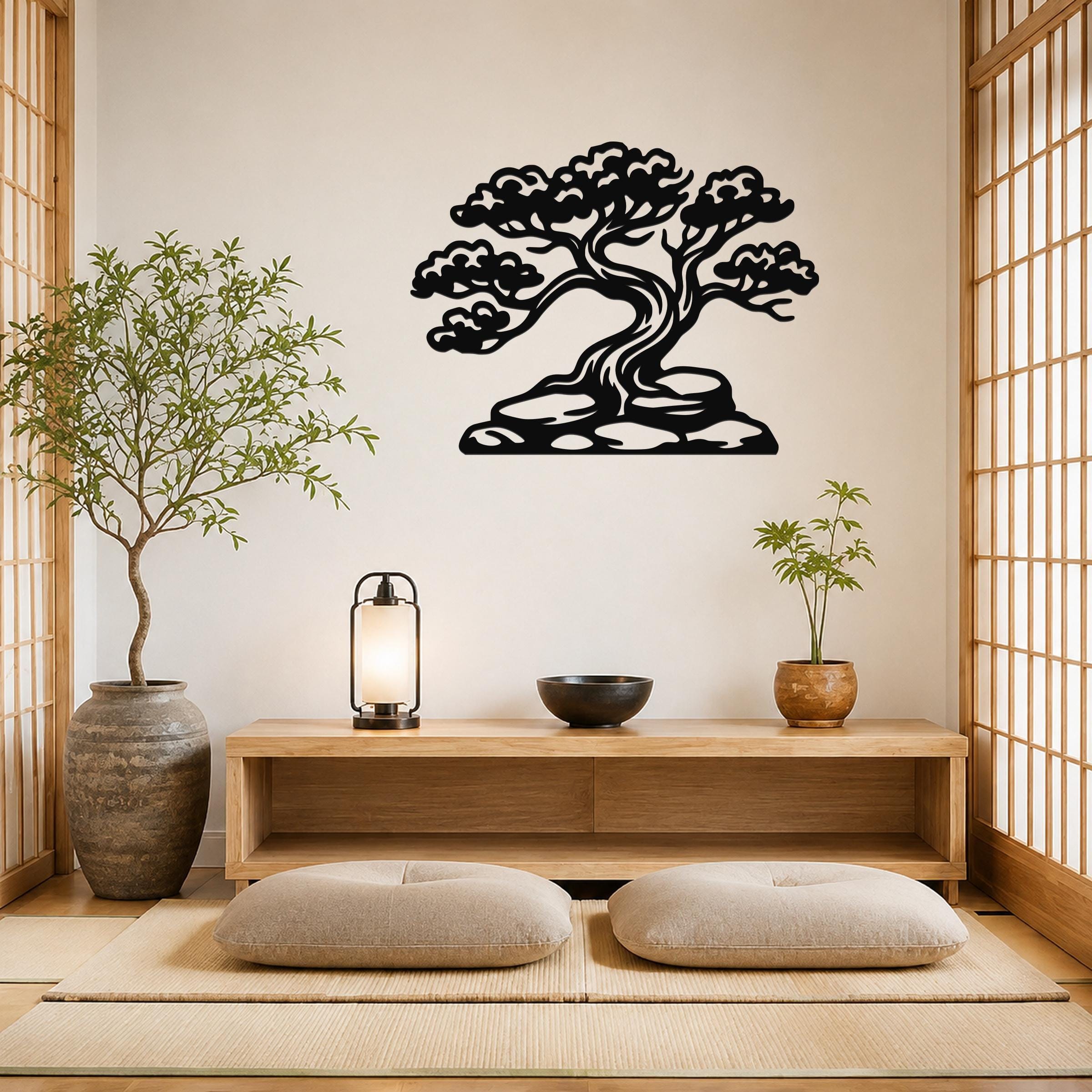 Black metal wall art of a bonsai tree silhouette with detailed branches and roots, mounted on a wall above a wooden console in a minimalist room.