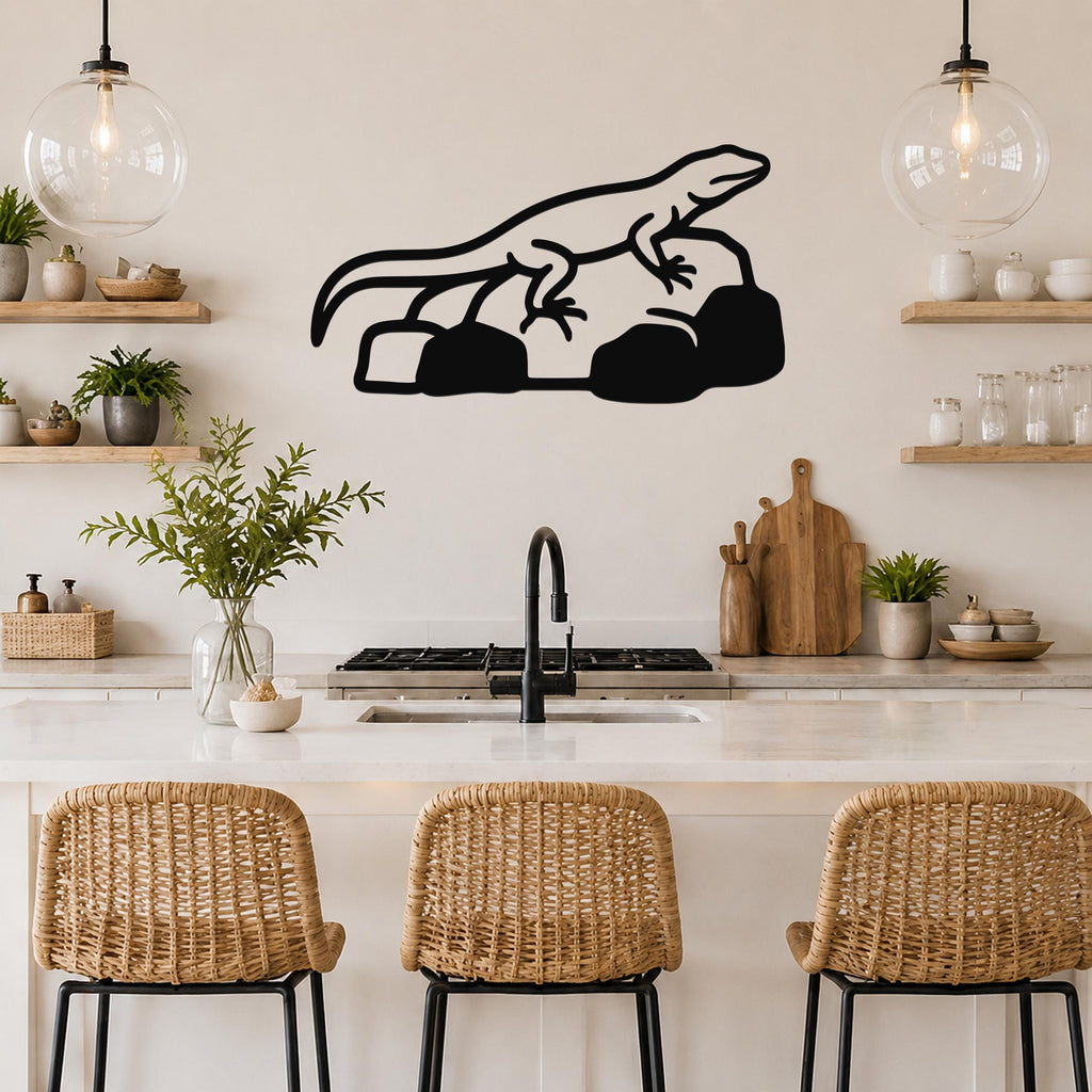 Black metal lizard wall art silhouette with internal cutout details, mounted above a kitchen counter in a modern rustic kitchen.