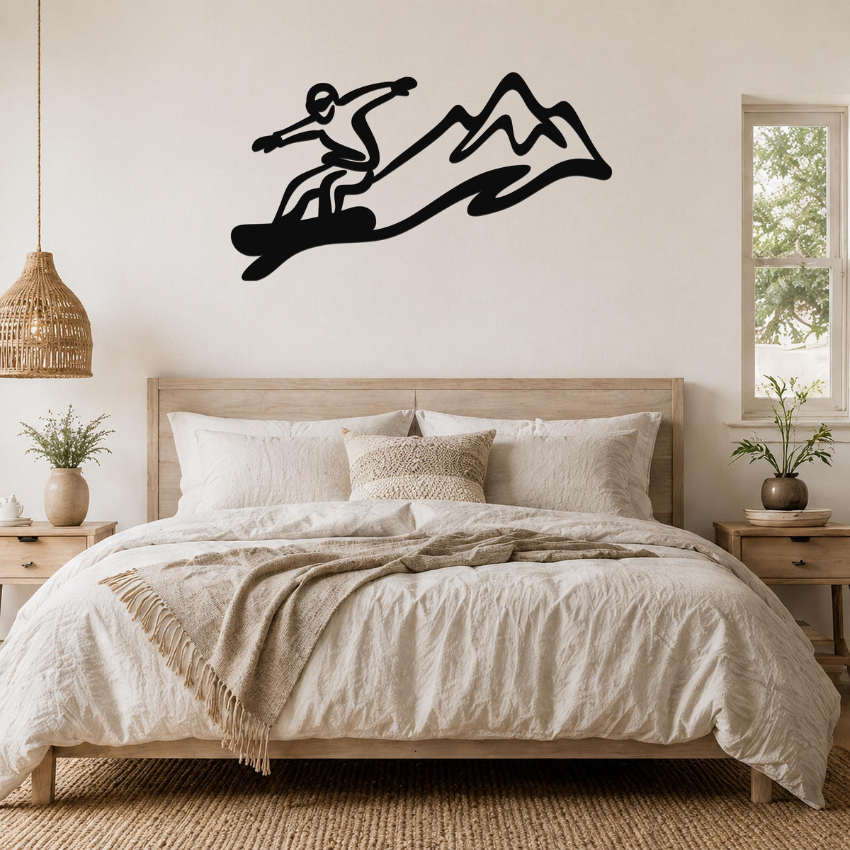 Black metal snowboarder wall art with mountain silhouette, mounted above a bed in a bedroom.