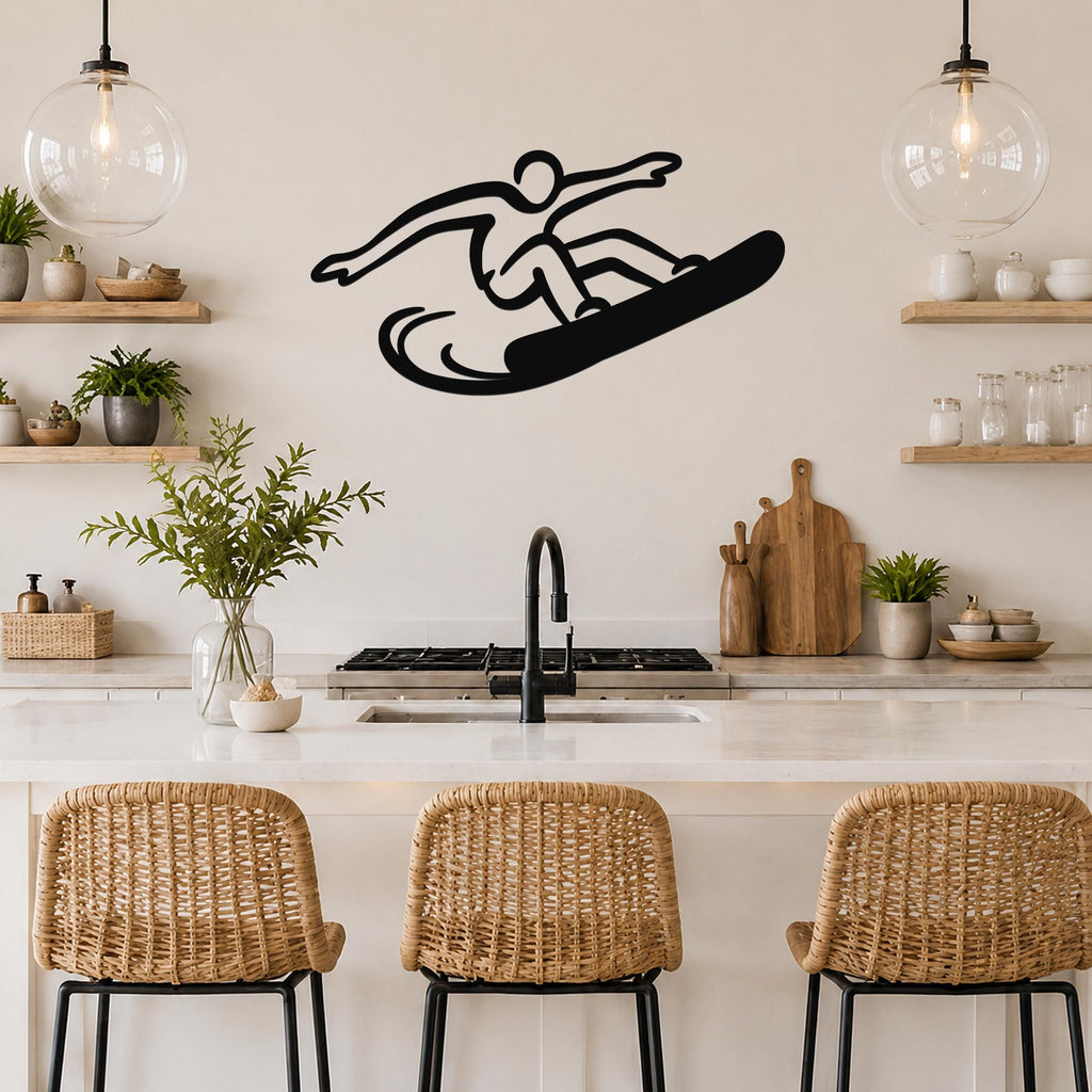 Black metal wall art silhouette of a snowboarder in motion, mounted on a kitchen wall above a counter with wicker bar stools.