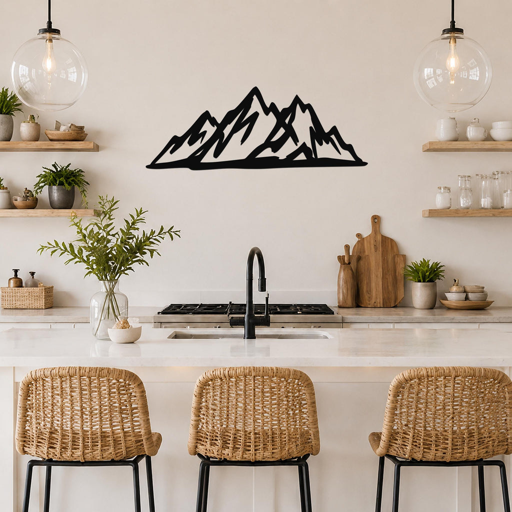 Black metal mountain silhouette wall art with layered peaks, mounted on a kitchen wall above a counter with wicker bar stools.