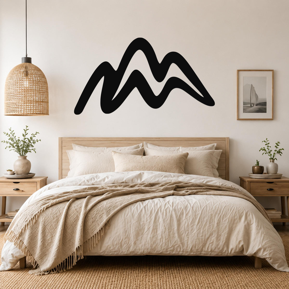 Black metal mountain silhouette wall art with flowing wave-like peaks, mounted above a wooden bed in a neutral bedroom.