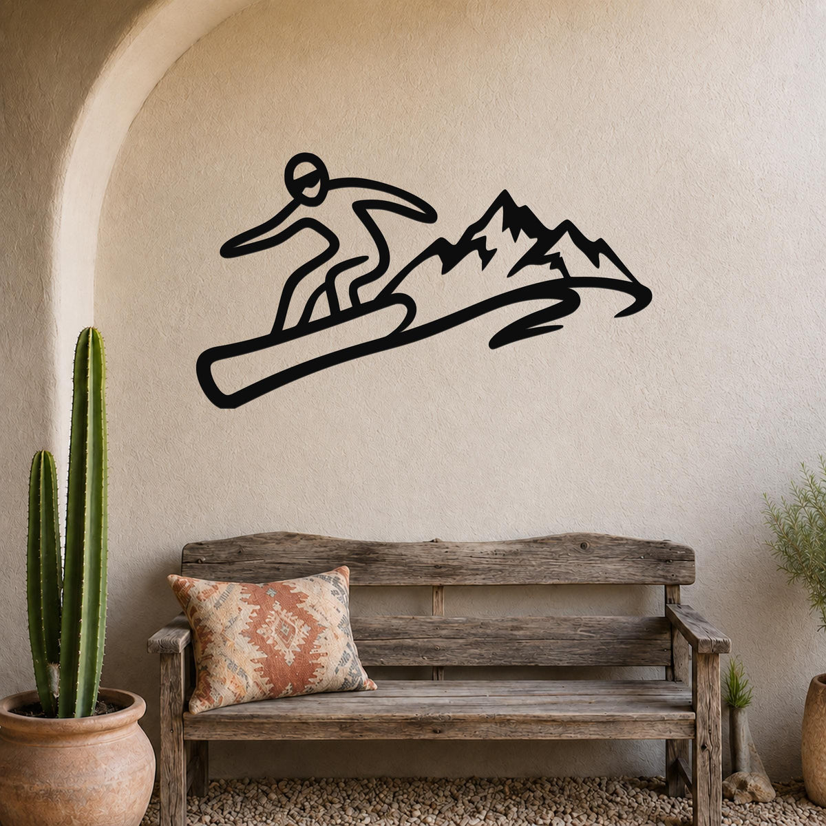 Black metal wall art silhouette of a snowboarder in motion above a wooden bench in a living room.