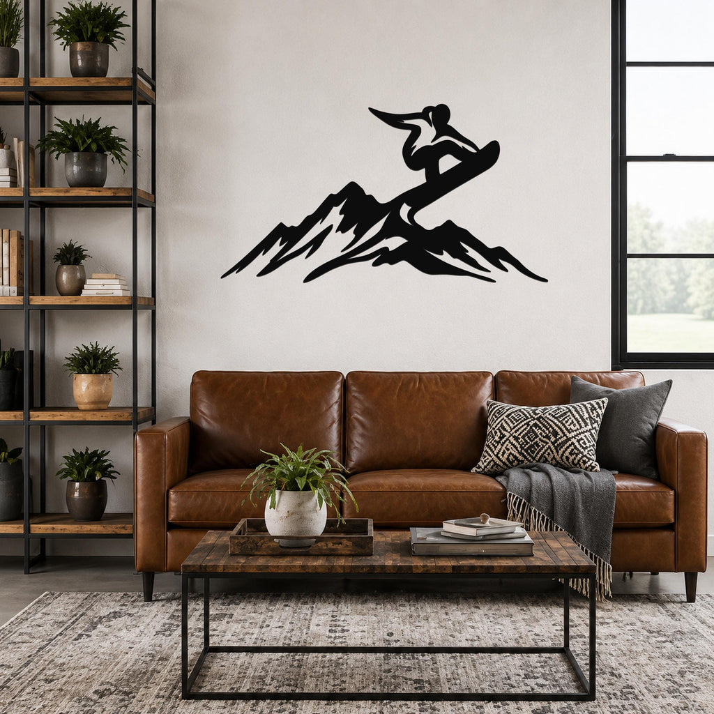 Black metal wall art silhouette of a snowboarder above a sofa in a living room.
