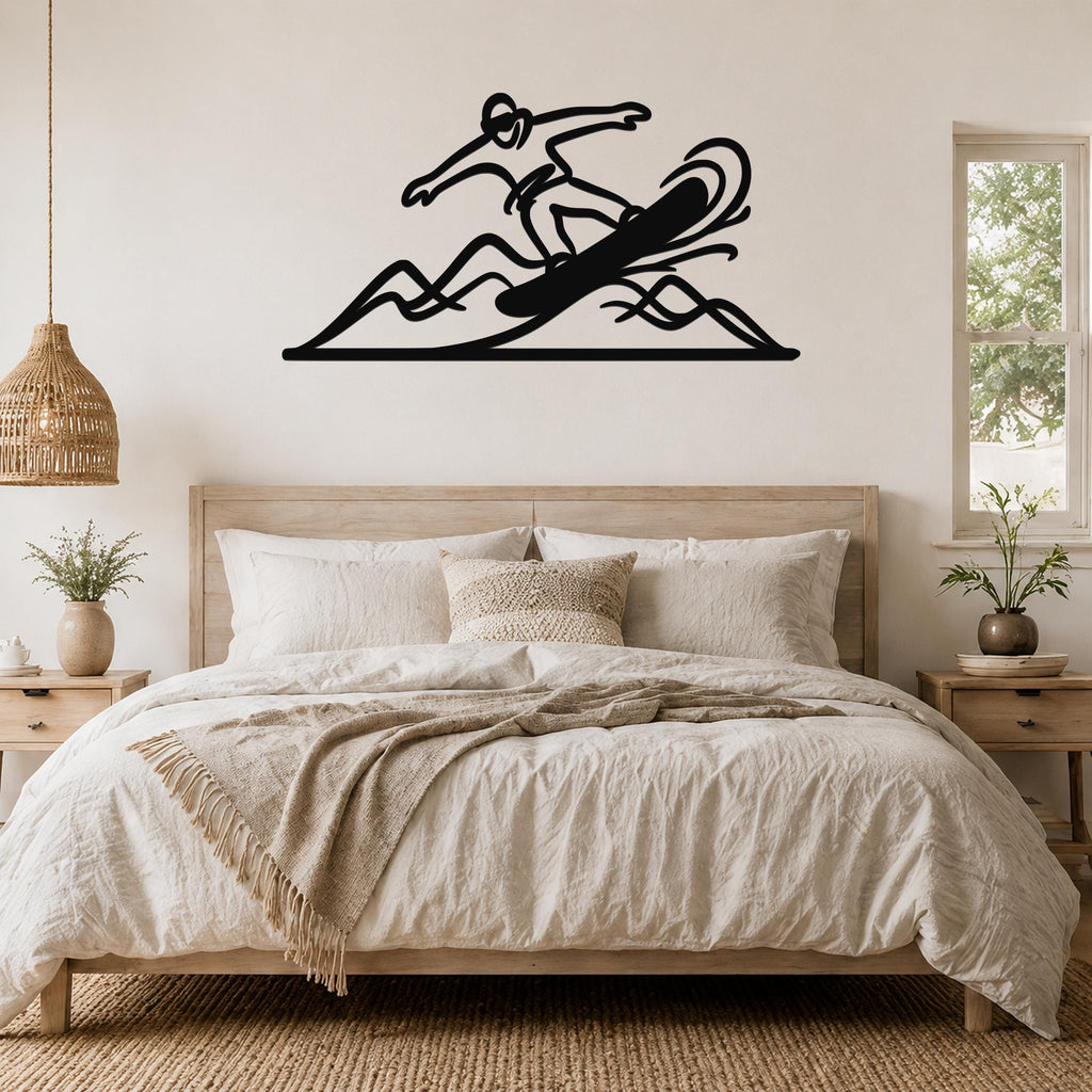 Black metal wall art silhouette of a snowboarder in motion above a bed, with dynamic wave cutouts, mounted on a bedroom wall.