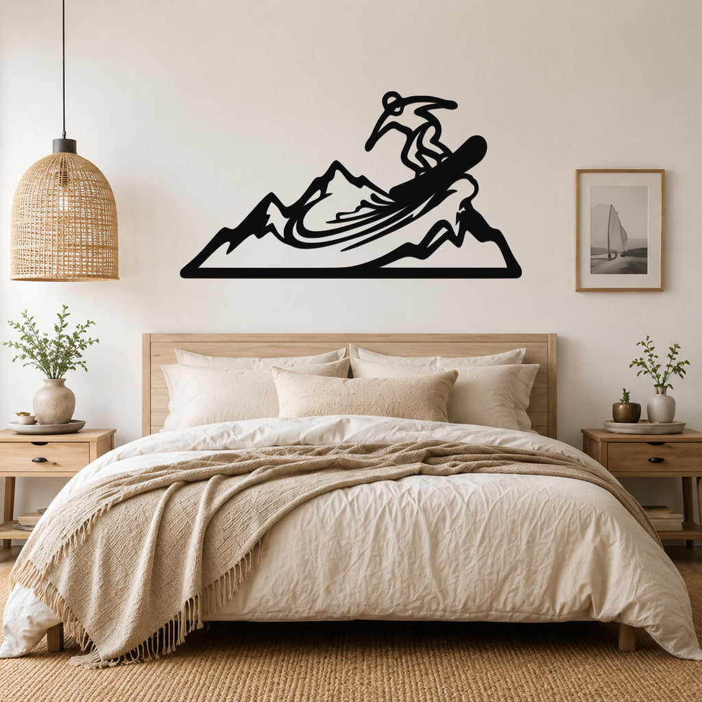 Black metal wall art cutout of a snowboarder on a mountain, mounted above a bed in a bedroom.