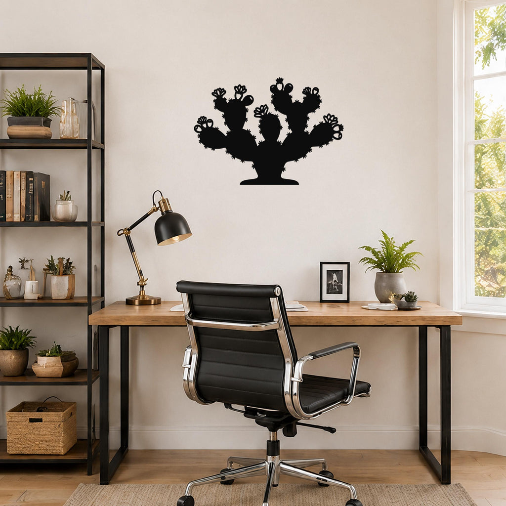 Black metal prickly pear cactus wall art with multiple arms and flower cutouts, mounted on a wall above a wooden desk in a home office.