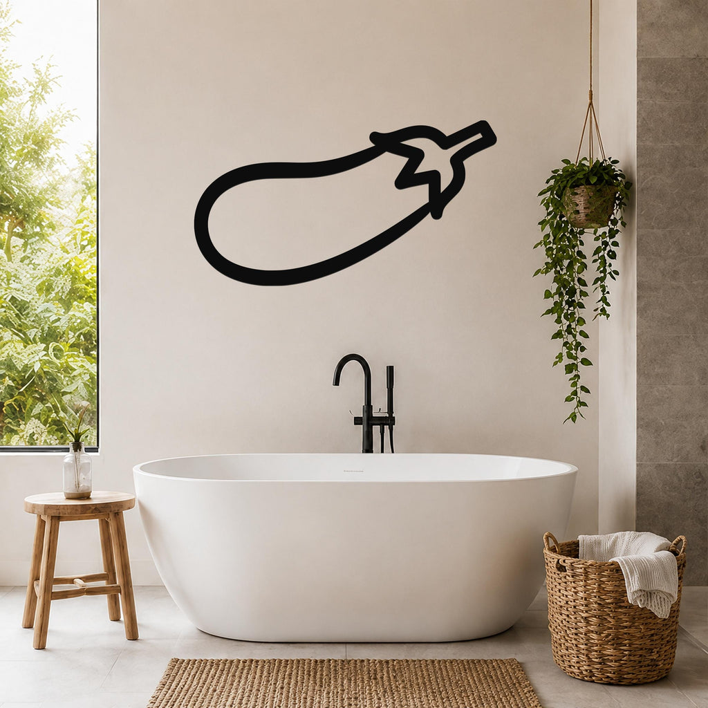 Black metal eggplant wall art silhouette mounted on a bathroom wall above a freestanding tub.