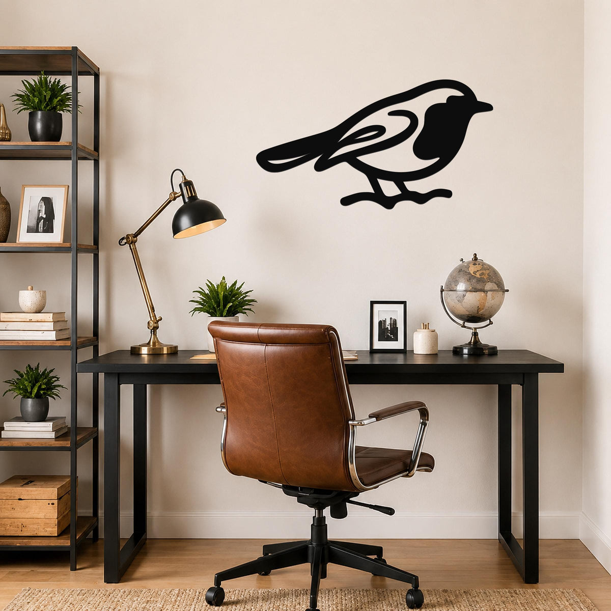 Black metal robin wall art silhouette mounted on a beige wall above a black desk in a home office.